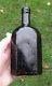 A Lovely Crude Octagonal Cross-hinged Pontilled Black Glass Utility Bottle