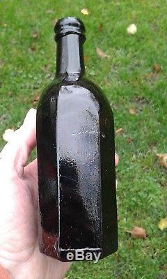 A Lovely Crude Octagonal Cross-Hinged Pontilled Black Glass Utility Bottle