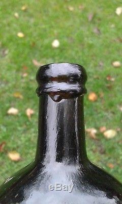 A Lovely Crude Octagonal Cross-Hinged Pontilled Black Glass Utility Bottle
