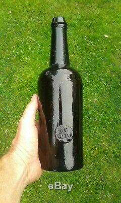 A Stunning Sealed T. C. C. R Trinity College Black Glass Bottle C1830