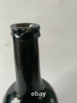 An antique black glass bottle from the end of the 18th. Century, onion bottle
