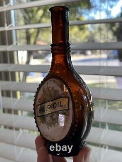 Antique Embossed Label Under Glass Amber Barber Bottle Hair Oil 7.5 (damaged)
