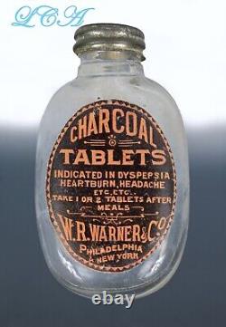 Antique WARNER CHARCOAL TABLET oval PILL BOTTLE embossed EARLY blown glass