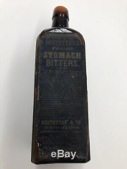 BLACK GLASS DR. HOSTETTERS BITTERS WITH BOTH PARTIAL LABELs