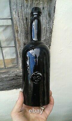 Early Black Glass Blown Sealed T C Wine Bottle