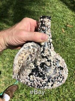 Early Black glass onion bottle covered with barnacles / Florida