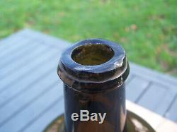 Early wine squat cylindrical bottle black glass circa 18th blowpipe pontil