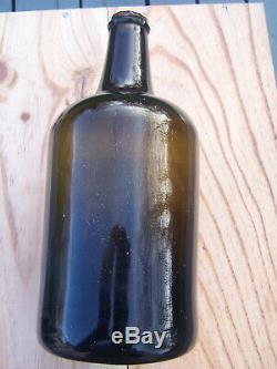 Early wine squat cylindrical bottle black glass circa 18th blowpipe pontil