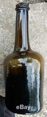 Fat bodied black glass cylinder pontilled wine bottle. Late 18th century