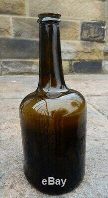 Fat bodied black glass cylinder pontilled wine bottle. Late 18th century