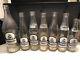 Lot Of (7) Seven Squeeze Soda Bottles Black And White Kids Logos Clear Glass