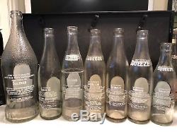 Lot of (7) Seven SQUEEZE Soda Bottles Black and White kids Logos Clear Glass