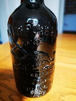 Newcastle Edinburgh Pictorial Black Glass Ginger Beer Bottle