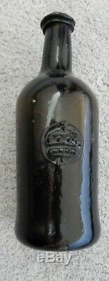 Very small black glass sealed wine bottle. Crown embossed seal. Late 18th century